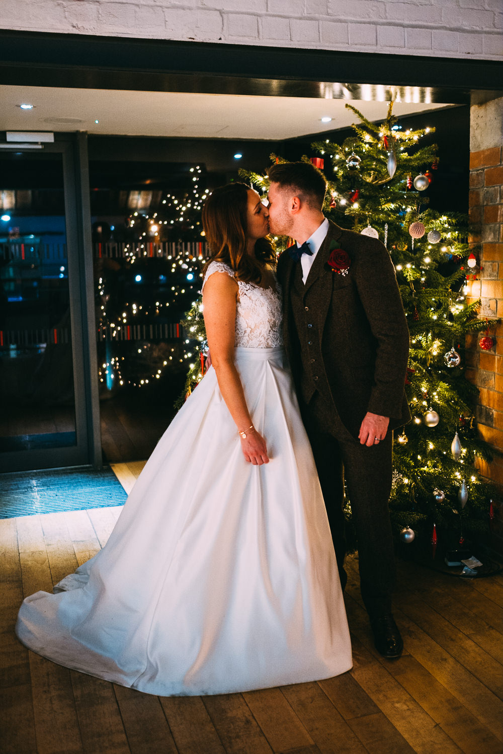 003 BRIDE AND GROOM ROMANTIC MOMENT IN FRONT OF CHRISTMAS TREE WEDDING PHOTOGRAPHY SWANSEA NATIONAL WATERFRONT MUSEUM WEDDING